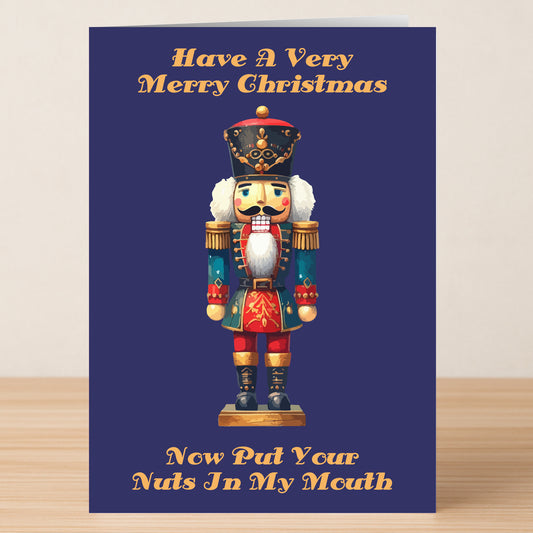 The In My Mouth Rude Christmas Card by Twisted Gifts features a nutcracker and the playful message, "Have A Very Merry Christmas. Now Put Your Nuts In My Mouth." Ideal for sending cheeky holiday greetings with a mischievous twist!.