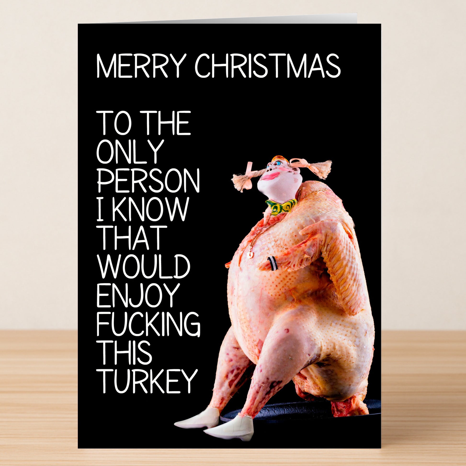 The Only Person Rude Christmas Card by Twisted Gifts features a funny raw turkey with human traits and reads: "Merry Christmas. To the only person I know that would enjoy fucking this turkey.