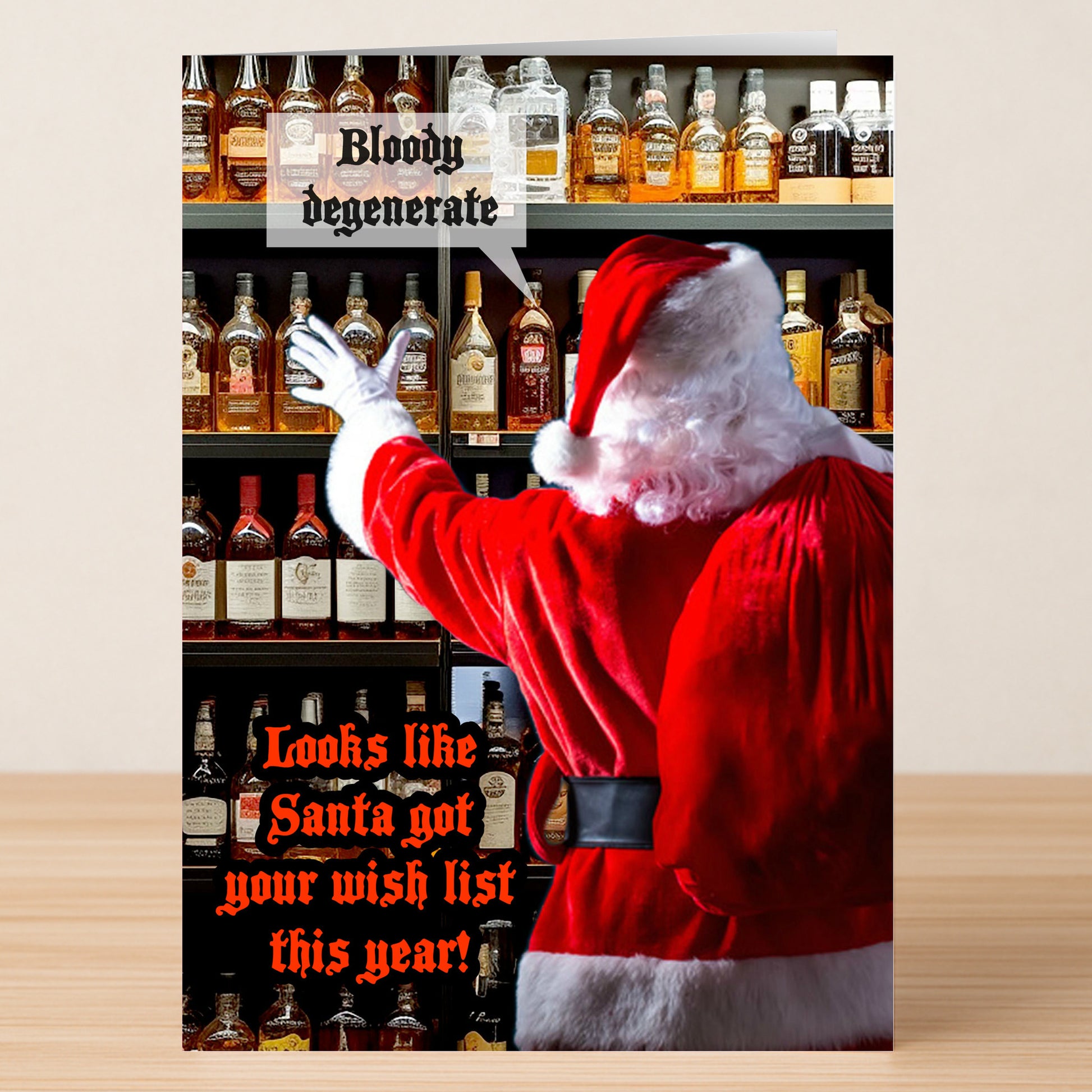 Santa grabs a bottle from a liquor shelf beside the text “Bloody degenerate” and “Looks like Santa got your wish list this year!” Degenerate Funny Christmas Card by Twisted Gifts is the perfect holiday humor card.