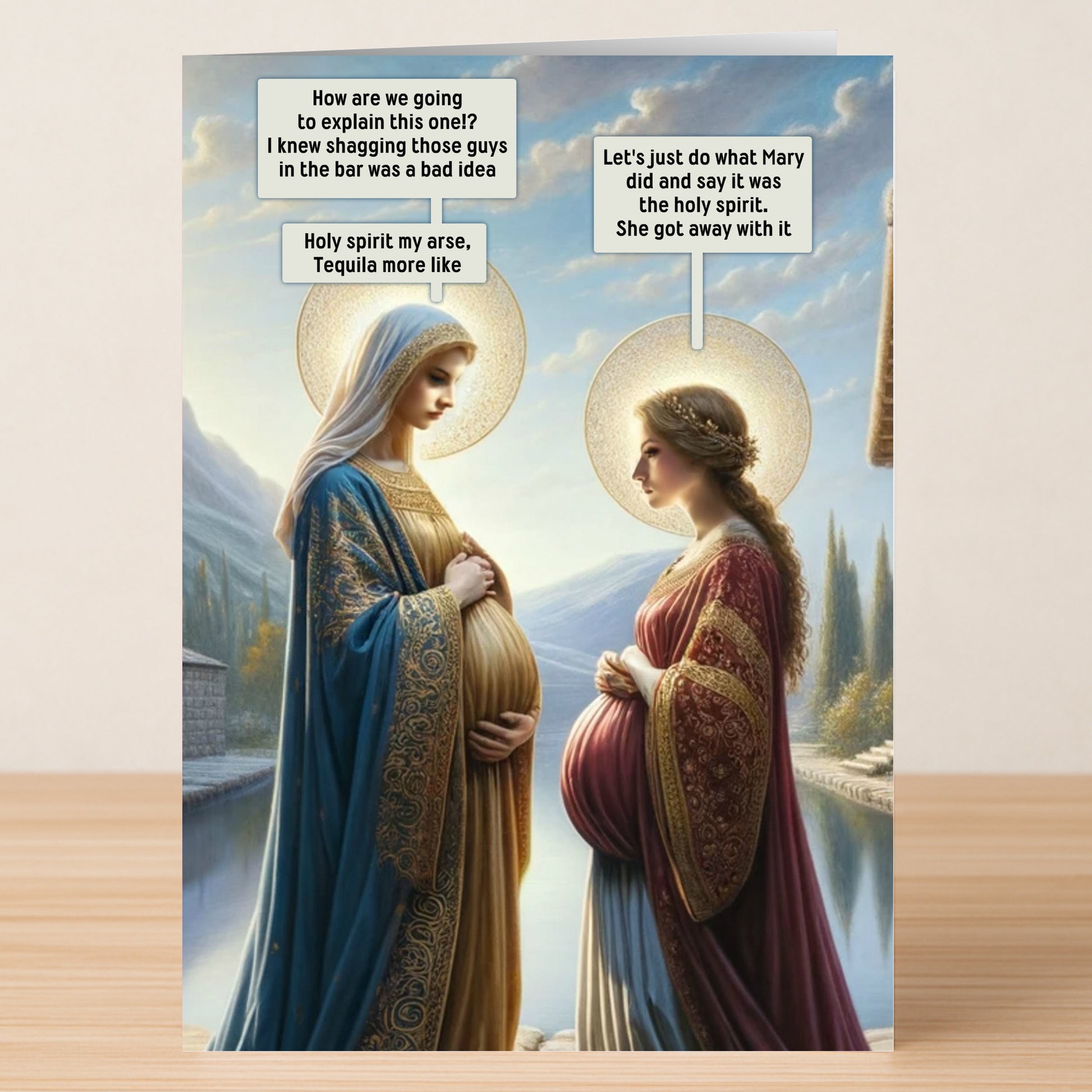 The Holy Spirit Funny Christmas Card by Twisted Gifts features two haloed, pregnant women styled as religious figures exchanging witty, Holy Spirit-inspired remarks about their pregnancies.