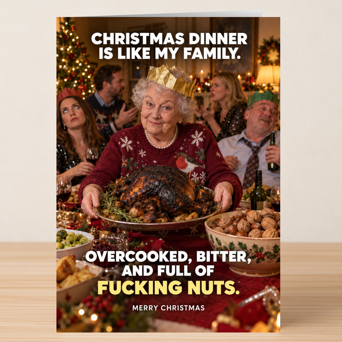 Full Of Nuts - Funny Christmas Card featuring an older woman in a paper crown holding a roast turkey at a dinner table, with text reading, “Christmas dinner is like my family. Overcooked, bitter, and full of nuts.”