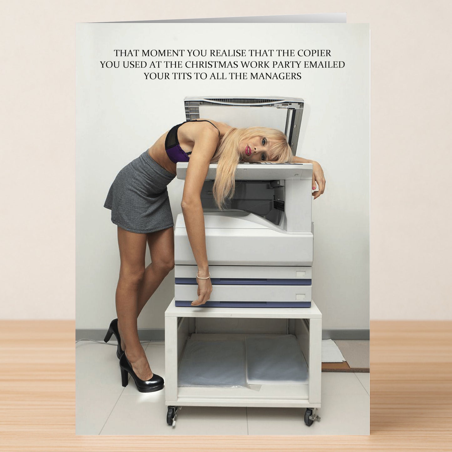 Send a hilarious holiday greeting with Twisted Gifts' Emailed Rude Christmas Card featuring a woman in a skirt and crop top discovering the photocopier just emailed her chest to all the managers—perfect for friends with a cheeky sense of humor!.