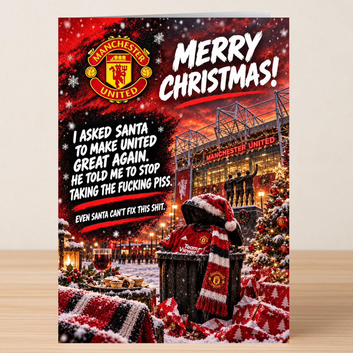 Man United – Funny Christmas Card featuring the Manchester United crest and Old Trafford with the text: “I asked Santa to make United great again. He told me to stop taking the fucking piss.”