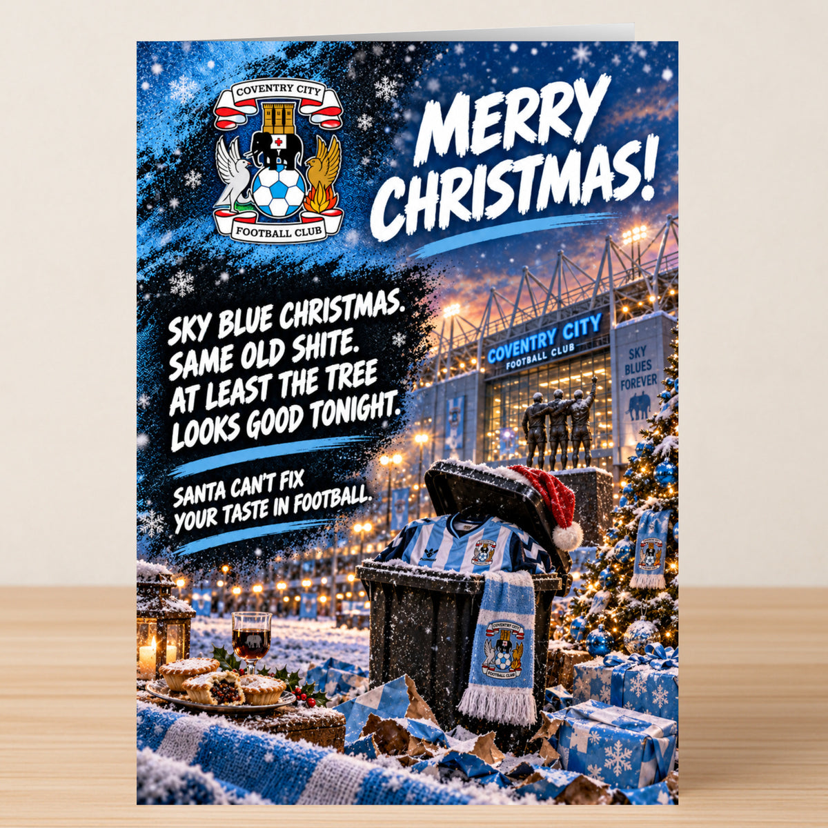 A Coventry City – Funny Christmas card featuring the team crest, a stadium at night, and a trash bin filled with merchandise, with the text: “Merry Christmas! Sky blue Christmas. Same old shite.”