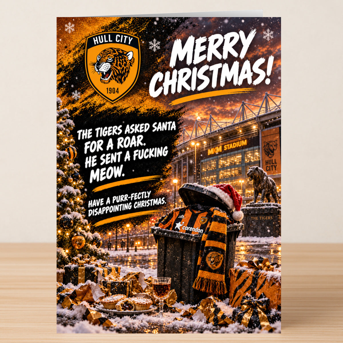 Hull City – Funny Christmas Card featuring a jersey and scarf in a stadium trash can with the text: “Merry Christmas! The tigers asked santa for a roar. He sent a fucking meow. Have a disappointing one.”