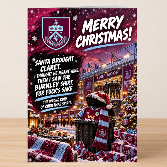 A Burnley – Funny Christmas Card featuring a Burnley jersey and scarf in a wooden crate against a stadium background, with a humorous message about Santa confusing wine for a soccer shirt.