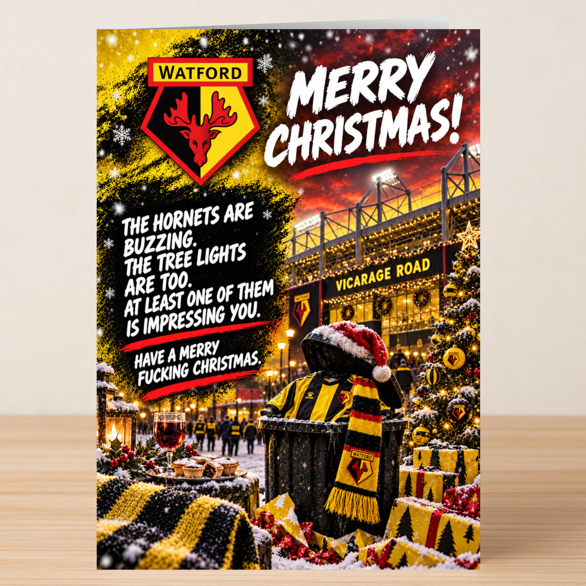 A Watford – Funny Christmas Card featuring the Watford FC logo, a night-lit stadium, and a trash can in a Santa hat and team scarf, with the text: “The Hornets are buzzing. The tree lights are too.”