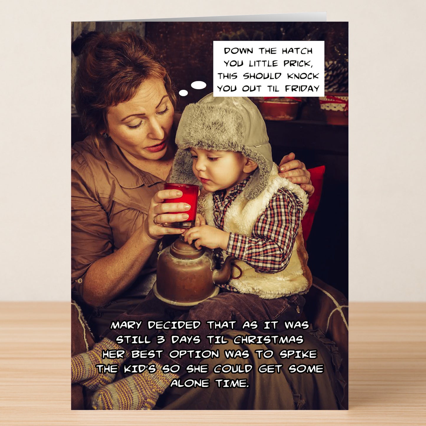 A woman helps a child drink from a red cup as funny, sarcastic text jokes about spiking the drink—perfect for spreading festive humor with the Down The Hatch Funny Christmas Card by Twisted Gifts.