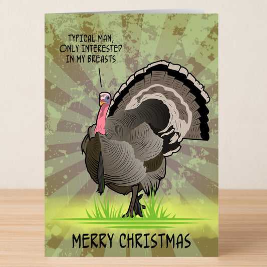 The Twisted Gifts "Typical Man Xmas Funny Christmas Card" features a cartoon turkey on grass with a speech bubble saying, "Typical man, only interested in my breasts." Text reads "Merry Christmas." A hilarious choice for holiday humor fans.