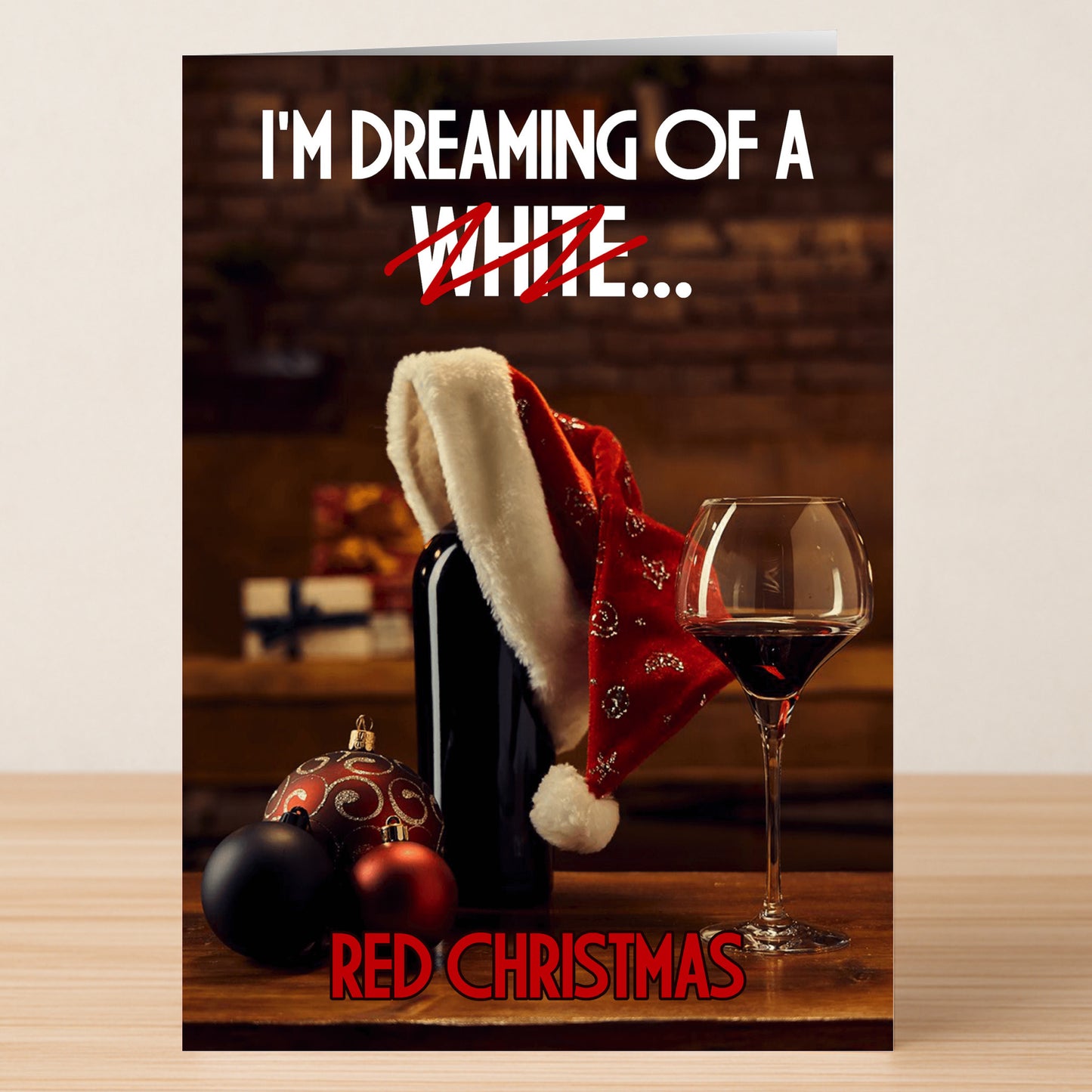 Twisted Gifts' Red Christmas Funny Christmas Card features a Santa hat on a wine bottle, glass of red wine, ornaments, and "I'm dreaming of a ~white~ red Christmas"—the perfect humorous card for your holiday greetings.