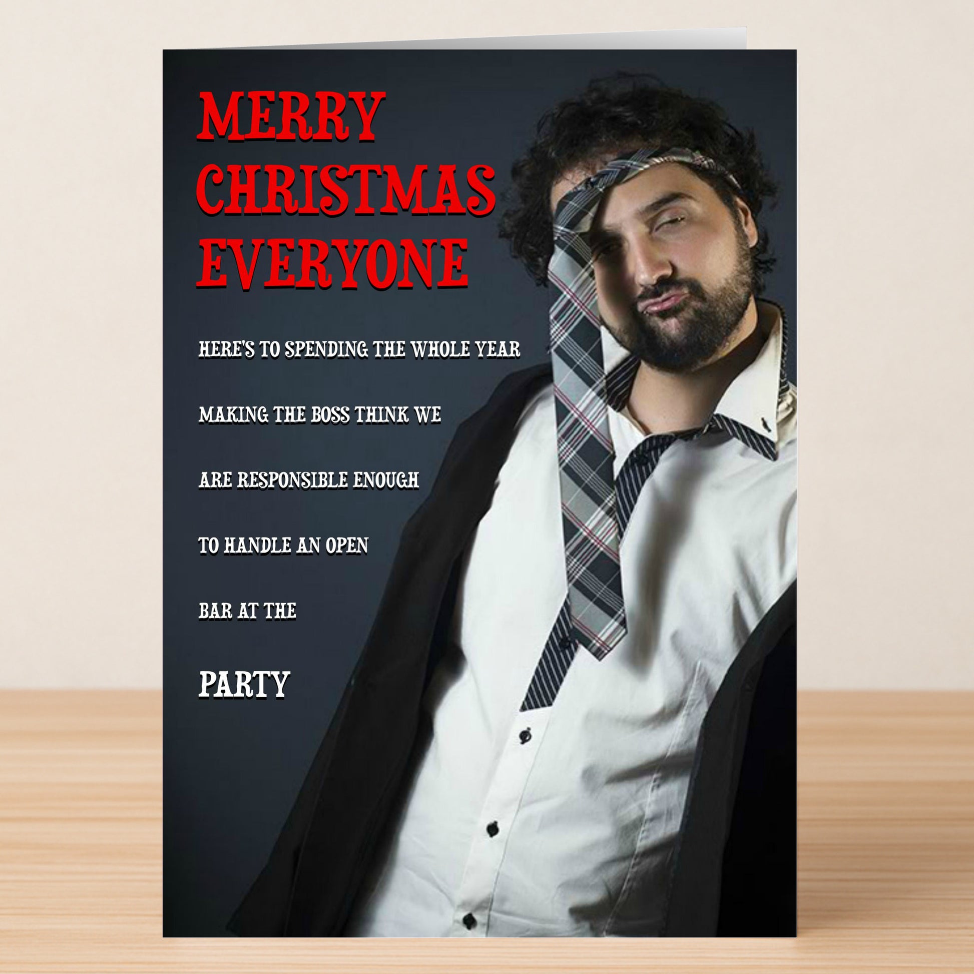 A disheveled man with a tie around his head stands by “Merry Christmas Everyone” and a humorous holiday message. This Open Bar Funny Christmas Card from Twisted Gifts is perfect for spreading cheer with a laugh.