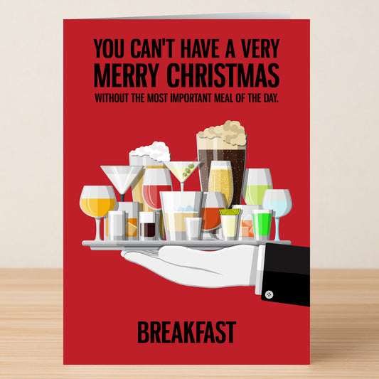 Send holiday cheer with the "Most Important Meal" funny Christmas card by Twisted Gifts, featuring a red background, gloved hand holding drinks, and cheeky breakfast text—perfect for sharing laughs this season!.