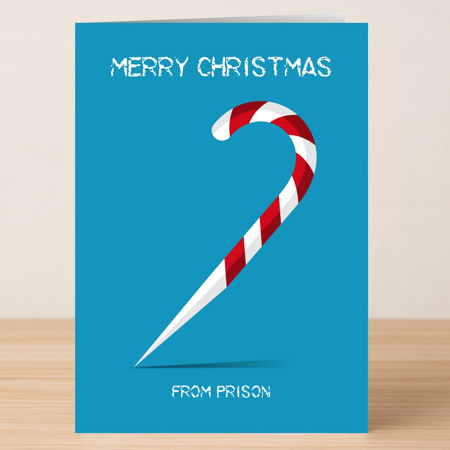 The Twisted Gifts Prison Funny Christmas Card features a blue card with a pointed candy cane and the text "Merry Christmas" on top, "From Prison" at the bottom—perfect for anyone with a sense of humor.