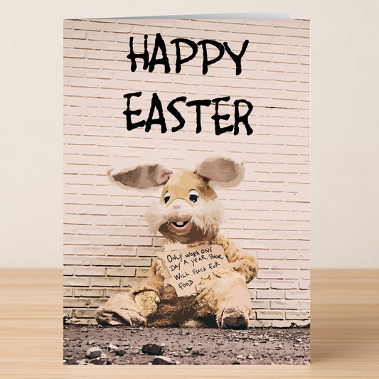 The Twisted Gifts "Fuck For Food Rude Easter Card" features a person in a shabby Easter Bunny suit holding a hilarious sign and is perfect for sharing some cheeky humor this holiday!.