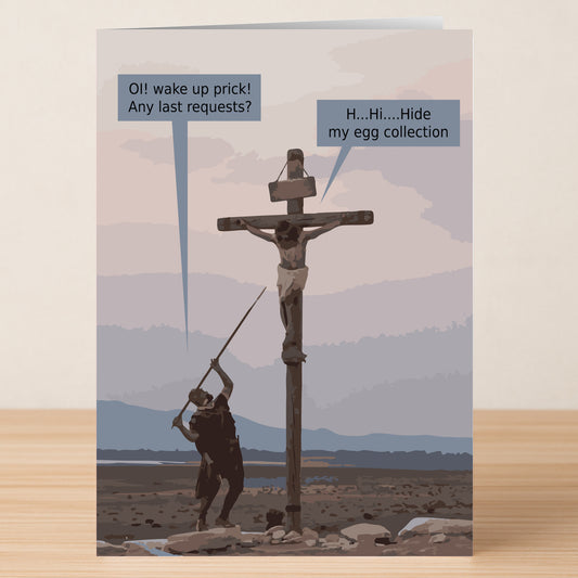 The Hide My Eggs Rude Easter Card by Twisted Gifts features a cartoon crucifixion scene with a funny twist—one character mocks the crucified man, who pleads, "Hide My Eggs," in a speech bubble.