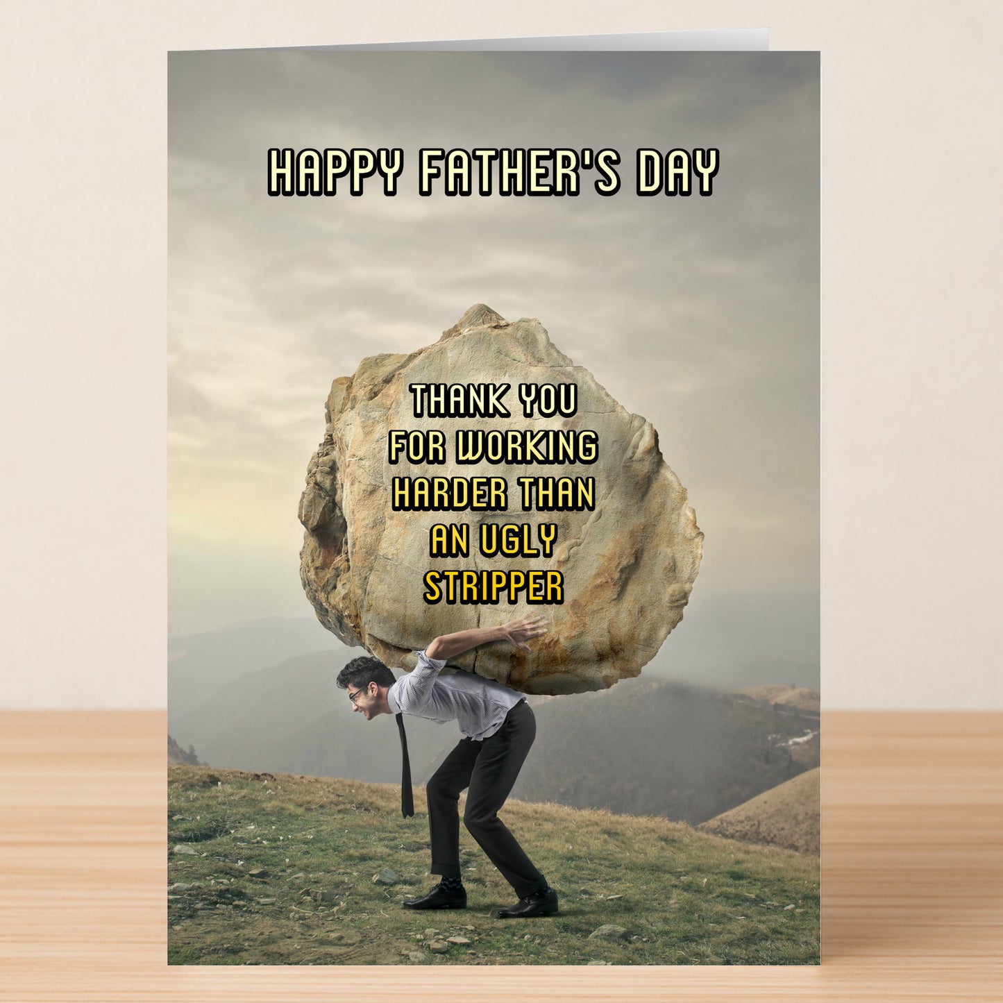 The Ugly Stripper Funny Father's Day Card by Twisted Gifts features a man carrying a giant boulder and reads: "Happy Father's Day. Thank you for working harder than an ugly stripper.