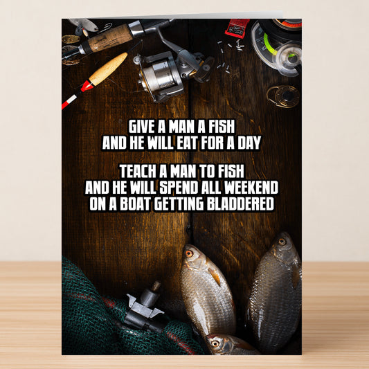 The Teach A Man Funny Father's Day Card by Twisted Gifts features fishing gear, two fish, and the humorous text: "Give a man a fish and he will eat for a day. Teach a man to fish and he'll spend all weekend on a boat getting bladdered.