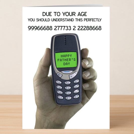 A hand holds an old Nokia phone with "Happy Father's Day" on screen—a cheeky nod for dads who mastered SMS slang. The Perfectly Rude Father's Day card by Twisted Gifts is ideal for vintage-texting fathers!.