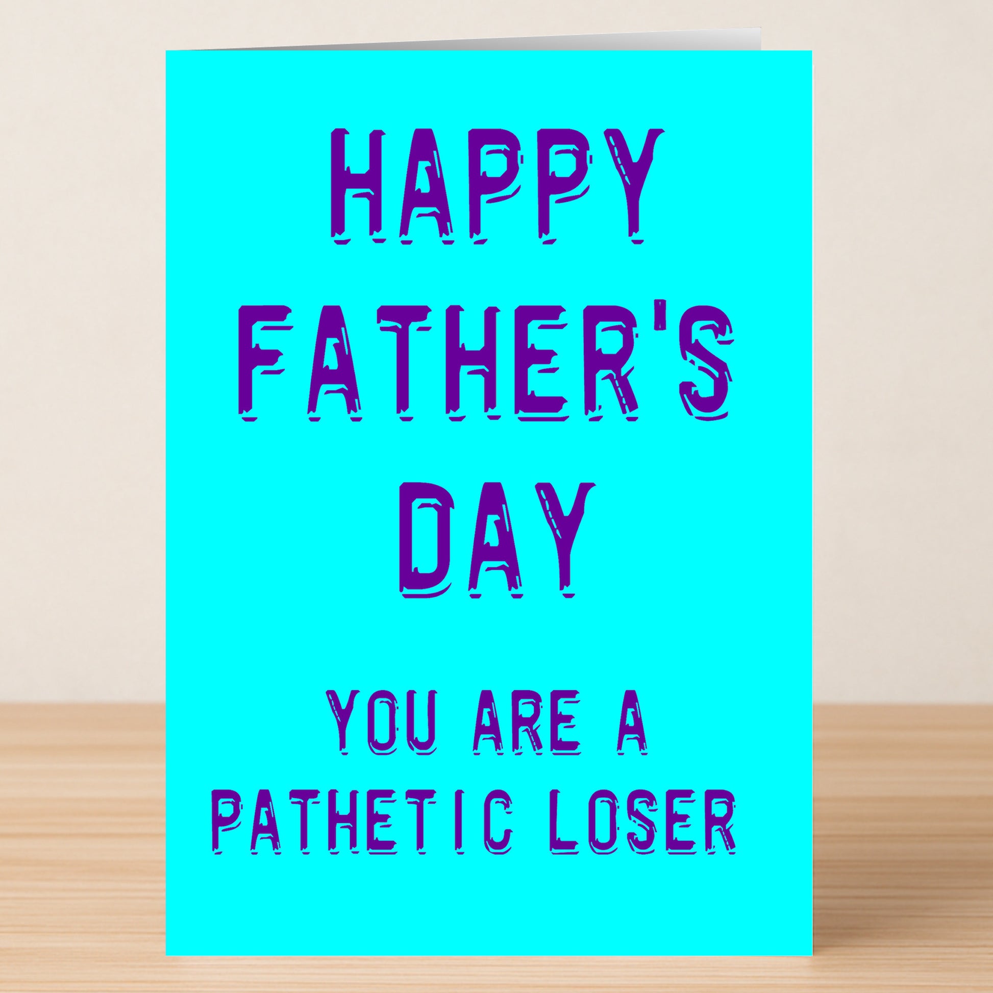 The Loser Rude Father's Day Card by Twisted Gifts is a blue greeting card with "Happy Father's Day. You are a pathetic loser." in bold blue-purple text—perfect for anyone who loves edgy humor.