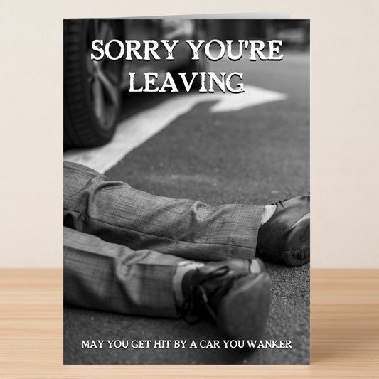 The Hit By A Car Rude Farewell Card by Twisted Gifts features "SORRY YOU'RE LEAVING" above a black-and-white car scene, with the cheeky message "MAY YOU GET HIT BY A CAR YOU WANKER" at the bottom.