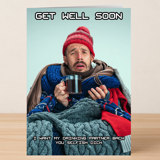 A man in winter clothes holds a mug, looking unwell. The Twisted Gifts Drinking Partner Insulting Get Well Soon Card says, "GET WELL SOON. I want my drinking partner back, you selfish dick.