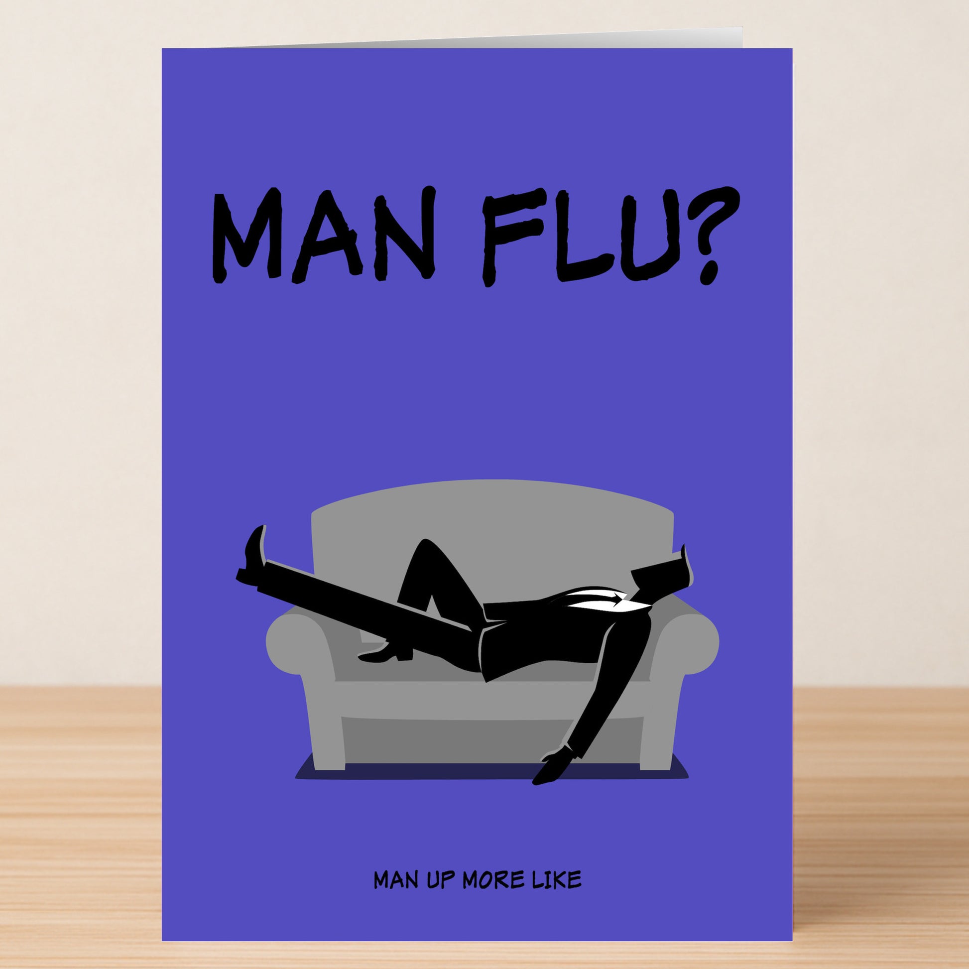 Cheer up loved ones with the Twisted Gifts Man Flu Insulting Get Well Soon Card—features a suited man lying dramatically, captioned "MAN FLU?" above and "MAN UP MORE LIKE" below, packed with sass and sarcasm.