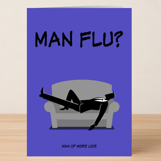 Cheer up loved ones with the Twisted Gifts Man Flu Insulting Get Well Soon Card—features a suited man lying dramatically, captioned "MAN FLU?" above and "MAN UP MORE LIKE" below, packed with sass and sarcasm.