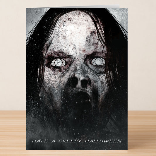 The Creepy Funny Halloween Card by Twisted Gifts features a dark, ghostly face with hollow eyes and an open mouth, plus the message "Have a Creepy Halloween" at the bottom.