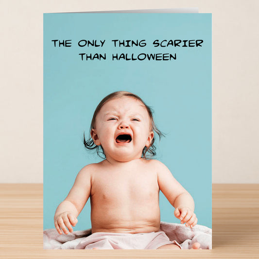 A crying baby sits on a blanket with the text, "The only thing scarier than Halloween." The Scarier Funny Halloween Card by Twisted Gifts is a witty greeting card that's sure to bring laughs this season.