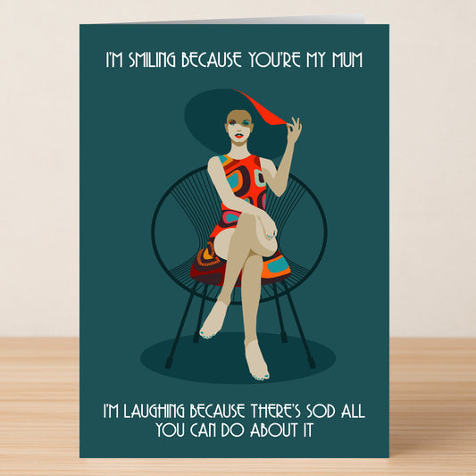 The I'm Smiling Funny Mother's Day Card by Twisted Gifts features a witty design and the text: "I'M SMILING BECAUSE YOU'RE MY MUM. I'M LAUGHING BECAUSE THERE'S SOD ALL YOU CAN DO ABOUT IT." Perfect for mums with a sense of humor!.
