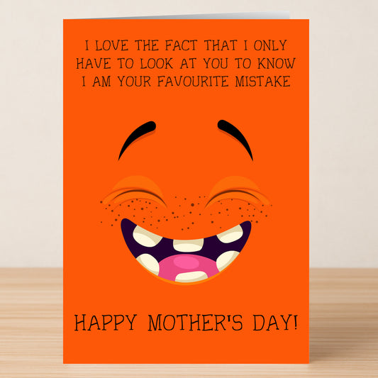 The Twisted Gifts Favourite Mistake Funny Mother's Day Card is an orange card with a big smiling face and the message: "I love the fact that I only have to look at you to know I am your favourite mistake. Happy Mother's Day!.