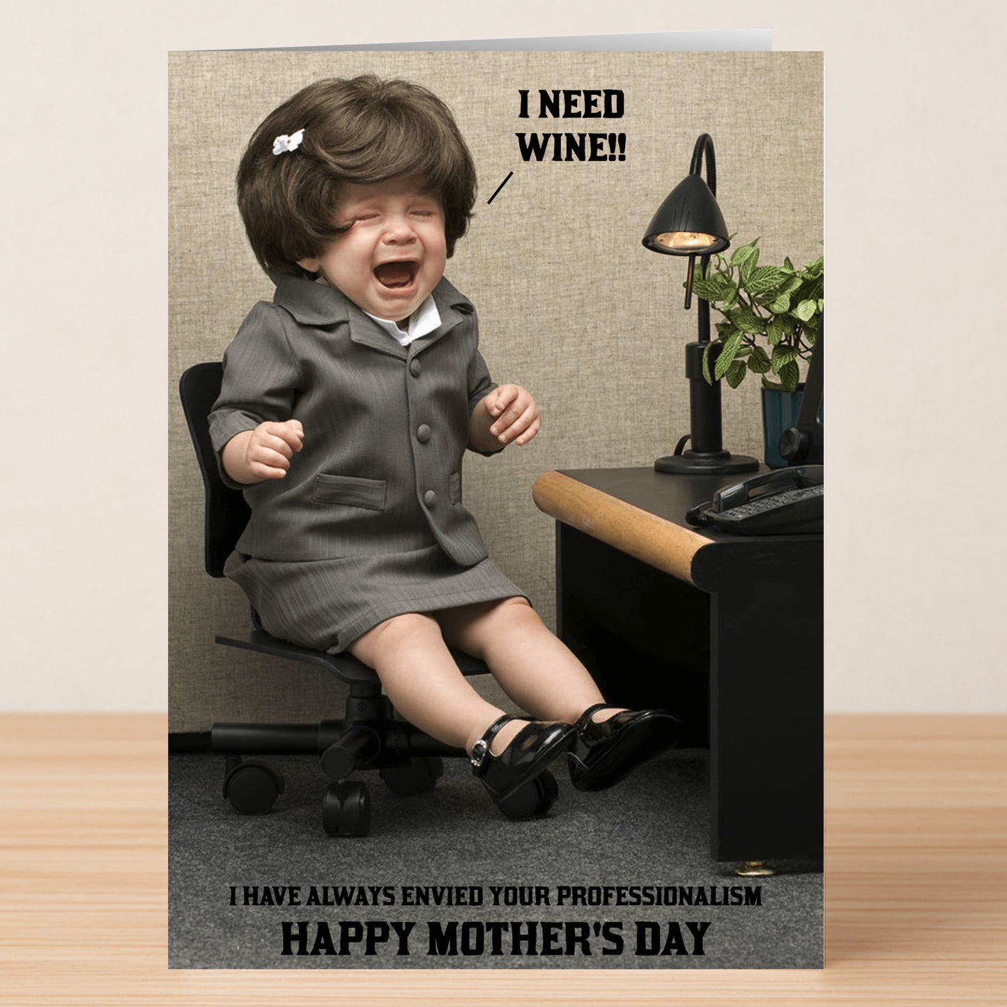 The Professionalism Funny Mother's Day Card by Twisted Gifts shows a baby in a suit crying at an office desk with "I NEED WINE!!" and "HAPPY MOTHER'S DAY"—a playful way to celebrate mom’s special day.