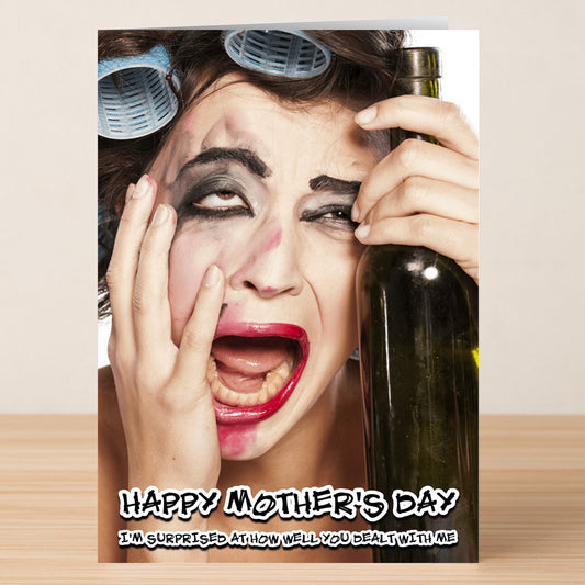 A distressed woman with messy makeup, curlers, and a wine bottle stars on the Dealt With Me Funny Mother's Day Card by Twisted Gifts. Text: "Happy Mother's Day. I'm surprised at how well you dealt with me.
