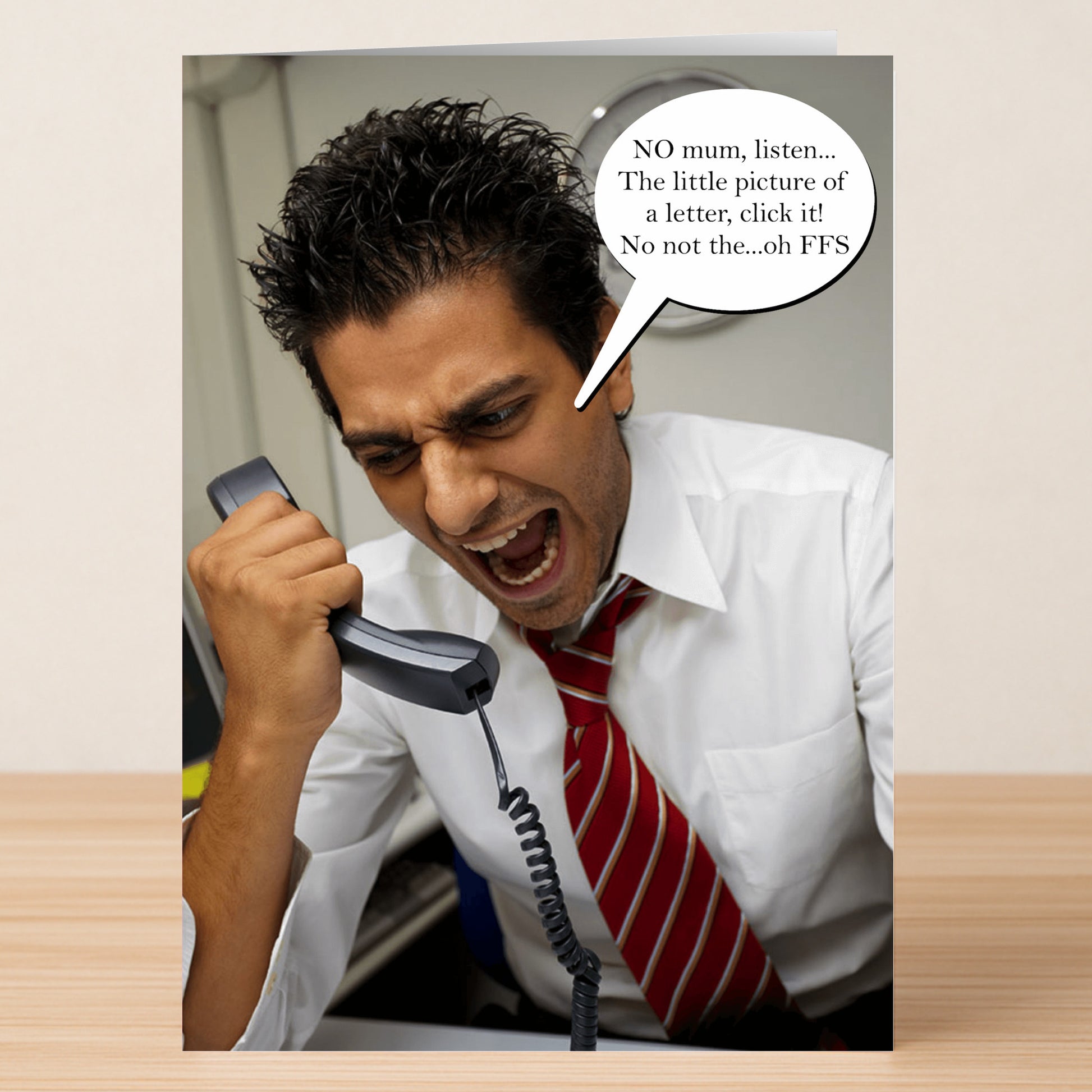 The Click It Funny Mother's Day Card by Twisted Gifts shows a man in a white shirt and red striped tie, frustrated while giving tech support to his mom. A hilarious choice for anyone who relates!.