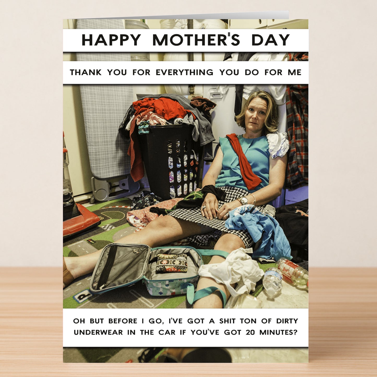 The Got 20 Minutes Funny Mother's Day Card by Twisted Gifts shows a tired woman in a messy laundry room, surrounded by clothes and clutter, with humorous text about Mother’s Day and dirty laundry.