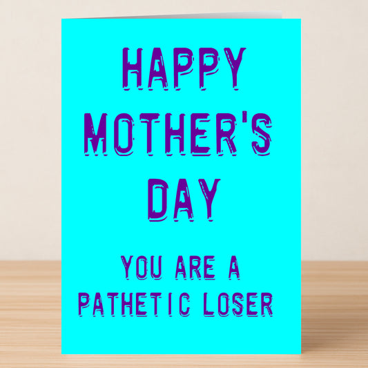 The Loser Insulting Mother's Day Card by Twisted Gifts features bold purple text on a bright blue card that says, "HAPPY MOTHER'S DAY YOU ARE A PATHETIC LOSER.