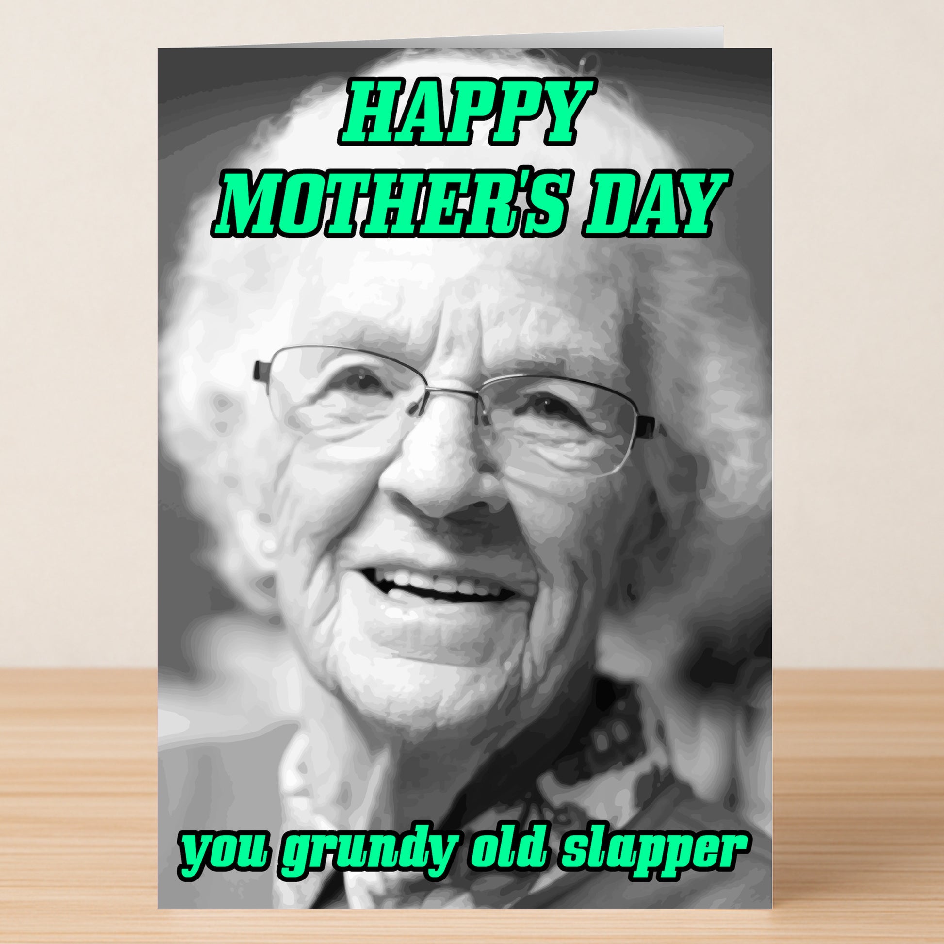 The Grundy Rude Mother's Day Card by Twisted Gifts features a black and white photo of a smiling elderly woman with "HAPPY MOTHER'S DAY you grundy old slapper" in bold green text—a cheeky card for mums who love attitude.
