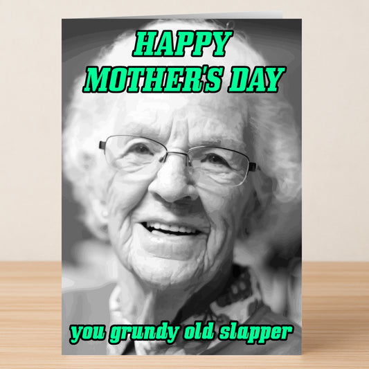 The Grundy Rude Mother's Day Card by Twisted Gifts features a black and white photo of a smiling elderly woman with "HAPPY MOTHER'S DAY you grundy old slapper" in bold green text—a cheeky card for mums who love attitude.