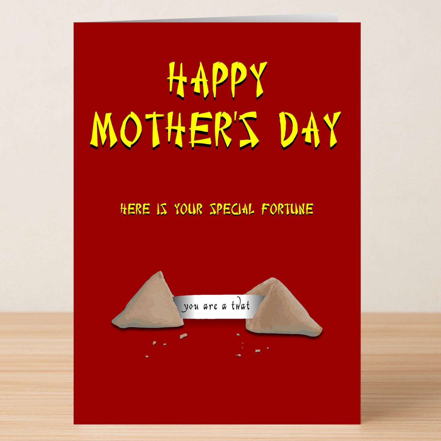 The Fortune Cookie Insulting Mother's Day Card by Twisted Gifts features a red design with yellow text and a fortune cookie illustration that reads, "you are a that." Ideal for moms who enjoy offbeat humor and playful insults.