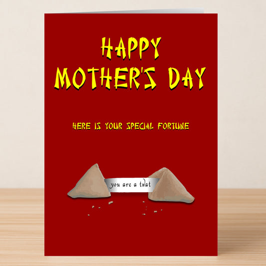 The Fortune Cookie Insulting Mother's Day Card by Twisted Gifts features a red design with yellow text and a fortune cookie illustration that reads, "you are a that." Ideal for moms who enjoy offbeat humor and playful insults.