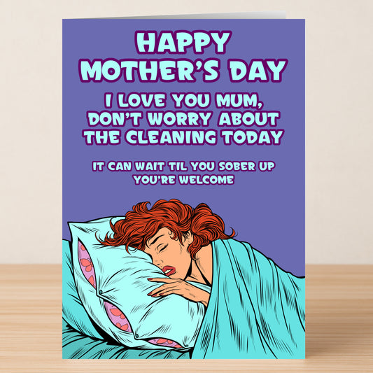 The "You're Welcome Funny Mother's Day Card" by Twisted Gifts features a playful cartoon of a mum sleeping in bed and the witty message: “Happy Mother’s Day. Don’t worry about the cleaning today. It can wait til you sober up. You’re welcome.”.