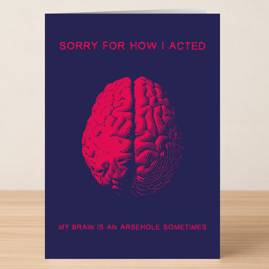 The Arse Brain Rude Sorry Card by Twisted Gifts features a bold red brain on navy with the message, "SORRY FOR HOW I ACTED. MY BRAIN IS AN ARSEHOLE SOMETIMES." A cheeky and humorous way to say sorry in style.