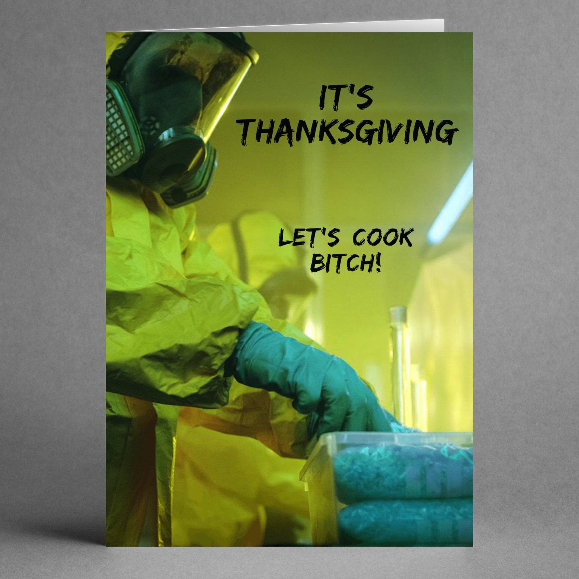 Dressed in a hazmat suit and gas mask, the person is meticulously handling a container, while the bold message on the Twisted Gifts' "Let's Cook Rude Thanksgiving Card" reads, "IT'S THANKSGIVING LET'S COOK BITCH!" This humorous card adds an edgy twist to the holiday spirit.