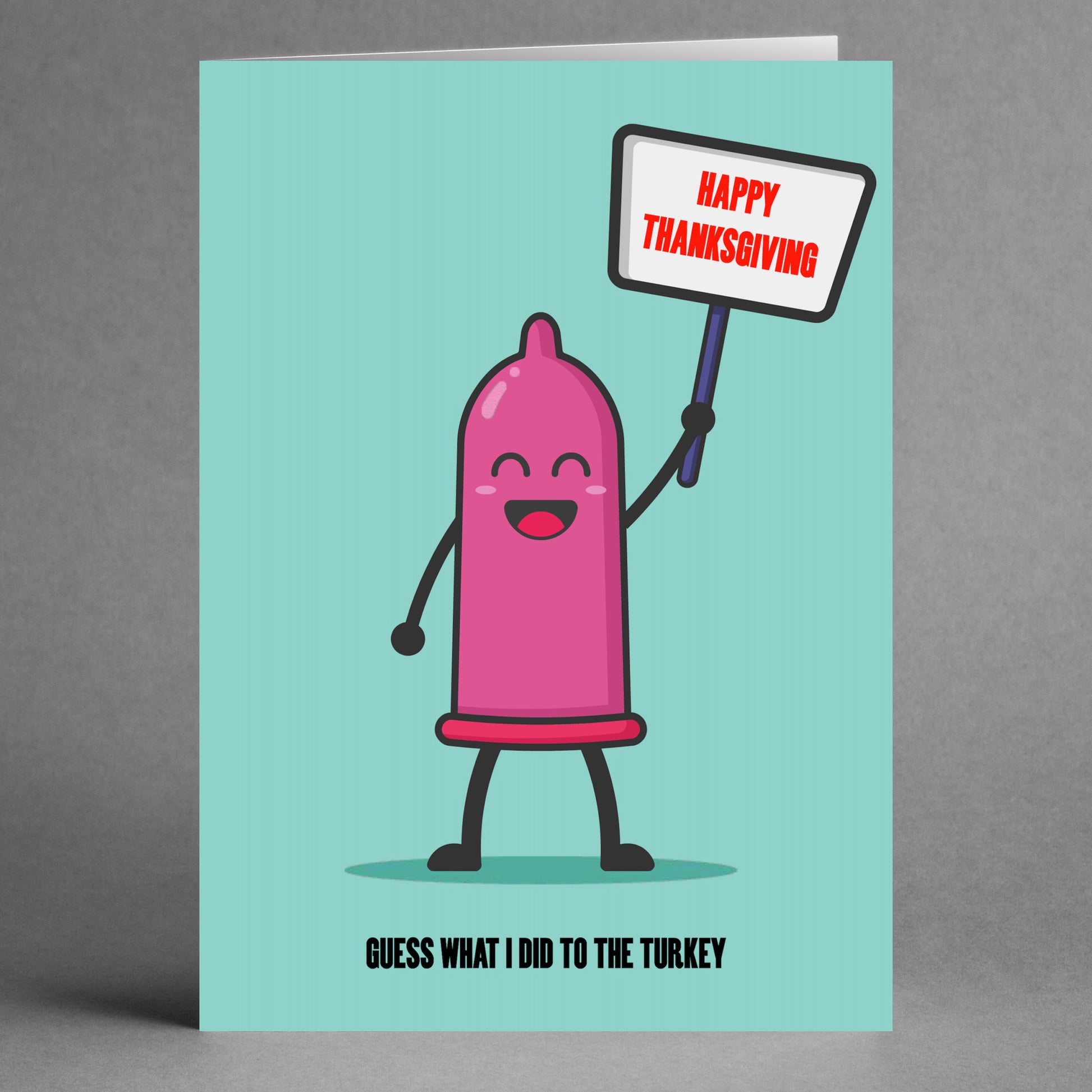 A cartoon condom character playfully holds a "Happy Thanksgiving" sign, with the line "Guess what I did to the turkey." This bold greeting card from Twisted Gifts is perfect for anyone who appreciates a cheeky and rude Thanksgiving twist.