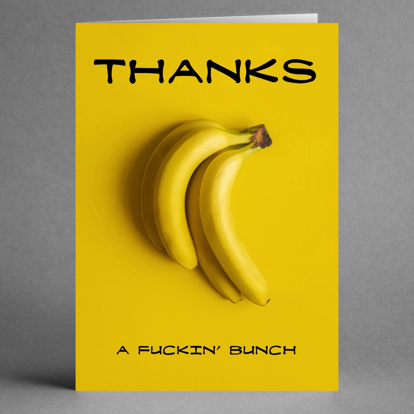 Introducing the "Thanks A Bunch Funny Thank You Card" by Twisted Gifts: This humorous greeting card features a bunch of bananas set against a bright yellow backdrop, with the cheeky phrase "Thanks a fuckin' bunch." It's an ideal way to show your gratitude with a playful touch.