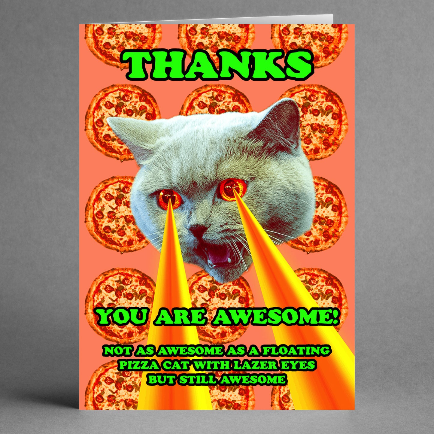 The Lazer Cat Insulting Thank You Card by Twisted Gifts showcases a vibrant design of a laser-eyed cat amidst floating pizzas. The card humorously states, "THANKS. YOU ARE AWESOME: Not as awesome as a floating pizza cat with laser eyes but still awesome," offering a quirky take on expressing gratitude.