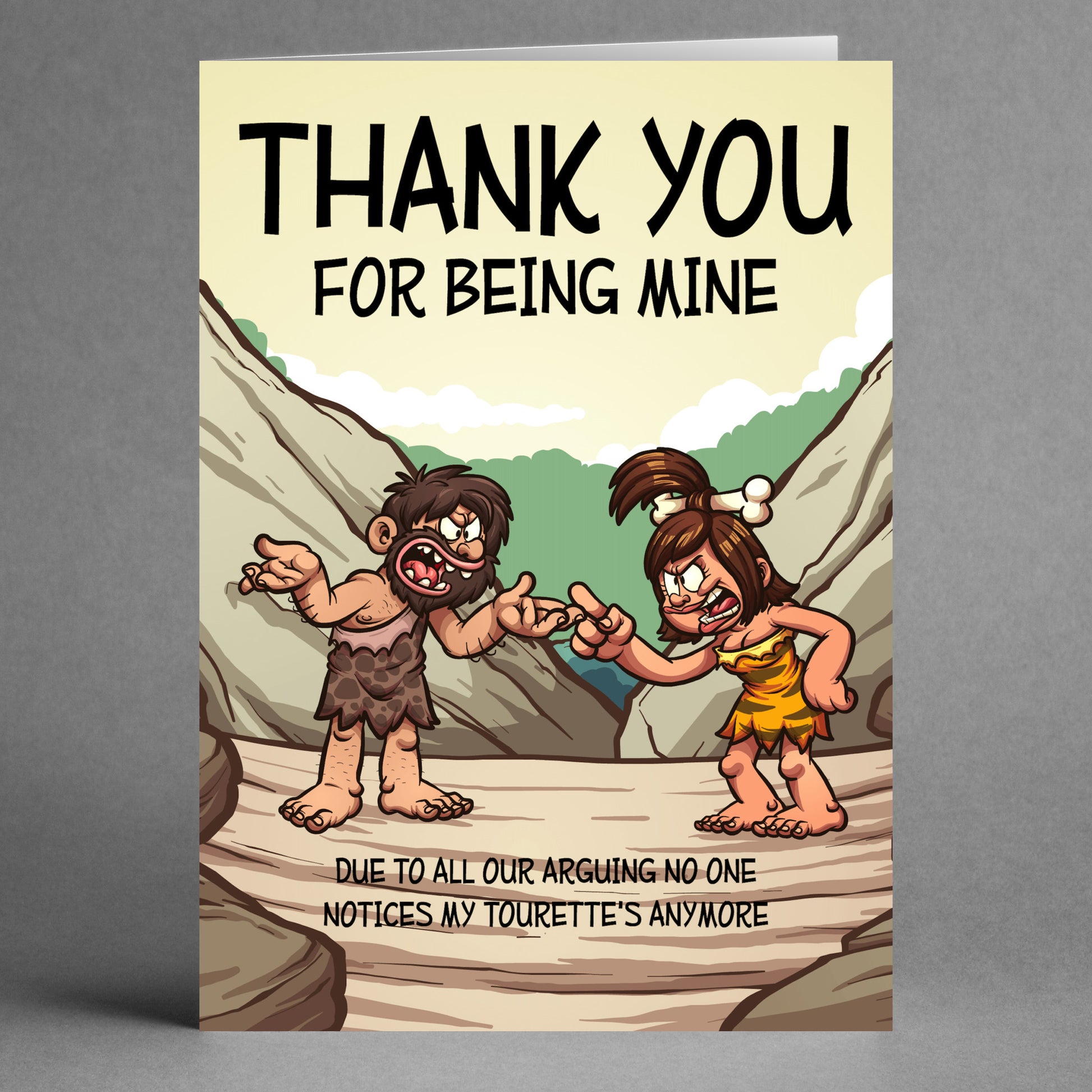 A humorous thank you card featuring cavemen in a comical argument, with the playful message: "Thank you for being mine. Due to all our arguing, no one notices my Tourette’s anymore." This card is part of Twisted Gifts' collection and is called the Tourettes Funny Thank You Card.