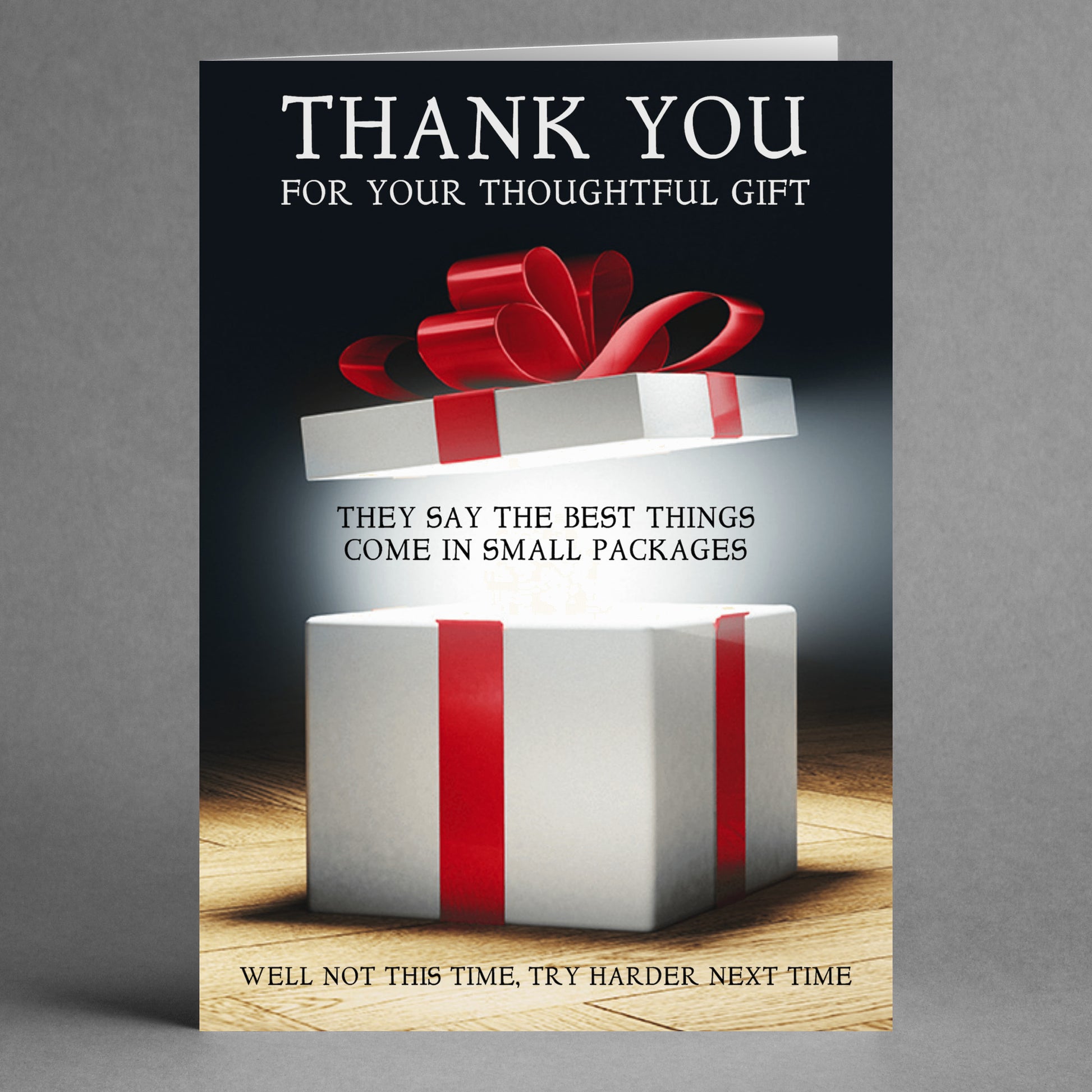 Introducing the "Small Packages Insulting Thank You Card" by Twisted Gifts. This humorous card features an image of a gift box with the text: "Thank you for your thoughtful gift. They say the best things come in small packages. Well, not this time—try harder next time." It's perfect as a funny greeting card to keep your friends on their toes!