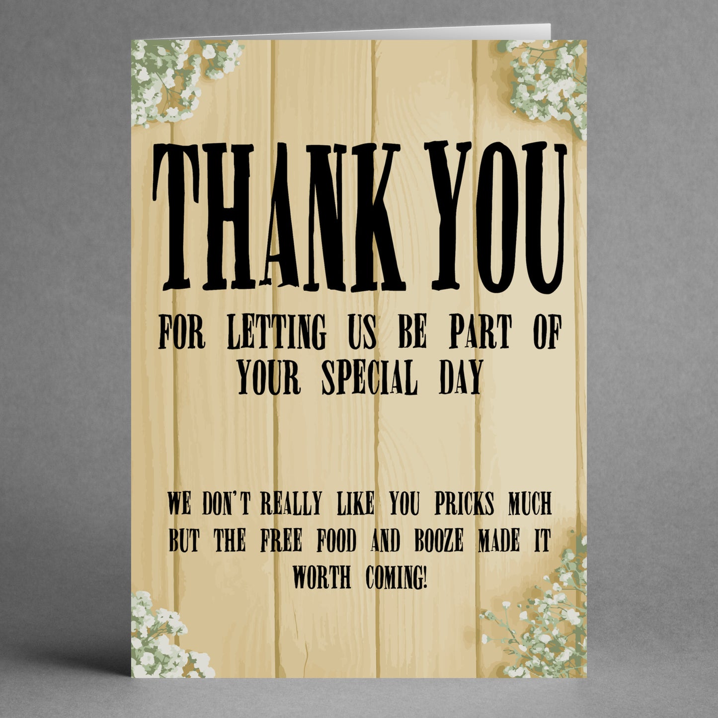 The "Worth Coming Insulting Thank You Card" by Twisted Gifts features a humorous message: "Thank you for letting us be part of your special day. We don’t really like you much, but the free food and booze made it worth coming." The wooden plank background gives this playful appreciation card a rustic charm.