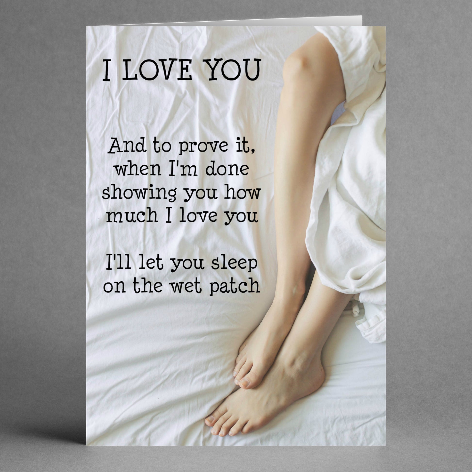 The "Wet Patch Rude Valentine's Card" by Twisted Gifts features the humorous text: "I LOVE YOU. And to prove it, when I'm done showing you how much I love you, I'll let you sleep on the wet patch," along with an image of legs on a white bed—ideal for those who enjoy humor in their Valentine's Day cards.